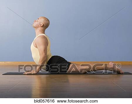 Stock Photograph - Hispanic man practicing yoga. Fotosearch