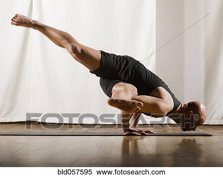 Stock Photography - Hispanic man practicing yoga. Fotosearch