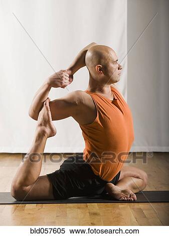 Stock Photography - Hispanic man practicing yoga. Fotosearch
