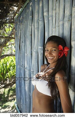 Hispanic woman in bikini leaning against bamboo View Large Photo Image Stock Image - Hispanic woman in bikini leaning against bamboo. Fotosearch