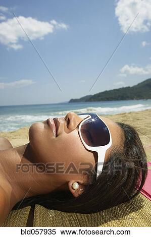Hispanic woman laying on beach View Large Photo Image Stock Photography - Hispanic woman laying on beach. Fotosearch