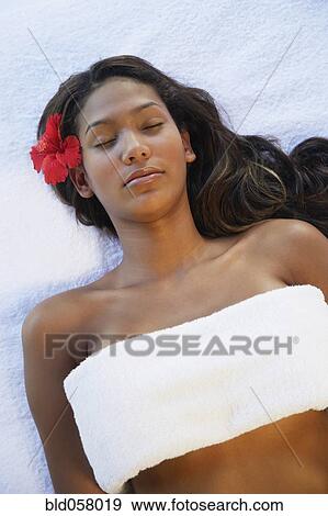 Hispanic woman laying on spa table View Large Photo Image Stock Photo - Hispanic woman laying on spa table. Fotosearch