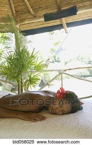 Hispanic woman laying on spa table View Large Photo Image Stock Photo - Hispanic woman laying on spa table. Fotosearch