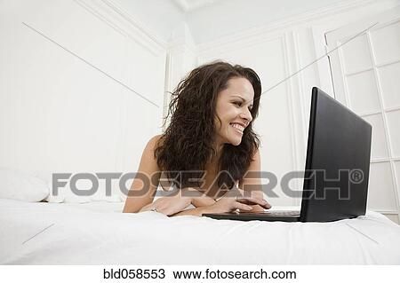 Hispanic woman looking at laptop View Large Photo Image Stock Image - Hispanic woman looking at laptop. Fotosearch