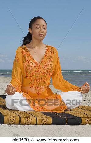 Stock Photo - Hispanic woman meditating. Fotosearch