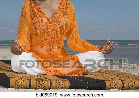 Stock Photo - Hispanic woman meditating. Fotosearch