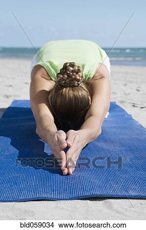 Picture - Hispanic woman practicing yoga. Fotosearch