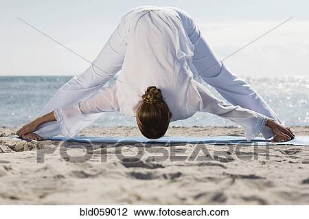 Stock Image - Hispanic woman practicing yoga. Fotosearch