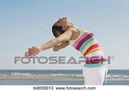 Stock Image - Hispanic woman practicing yoga. Fotosearch