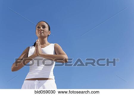 Stock Image - Hispanic woman practicing yoga. Fotosearch