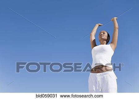 Stock Image - Hispanic woman practicing yoga. Fotosearch