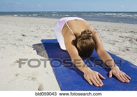 Stock Image - Hispanic woman practicing yoga. Fotosearch