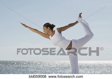 Stock Photo - Hispanic woman practicing yoga. Fotosearch