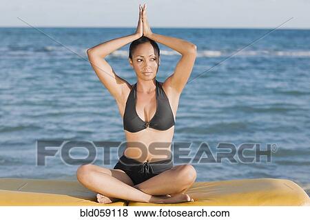 Hispanic woman practicing yoga View Large Photo Image Stock Photo - Hispanic woman practicing yoga. Fotosearch