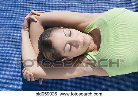 Stock Photograph - Hispanic woman practicing yoga. Fotosearch
