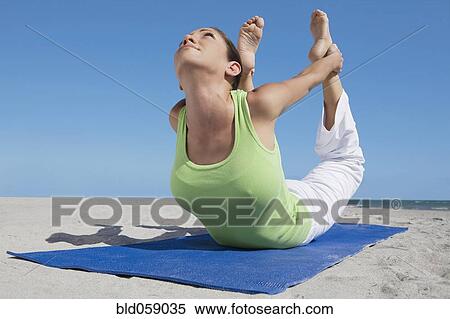 Stock Photography - Hispanic woman practicing yoga. Fotosearch