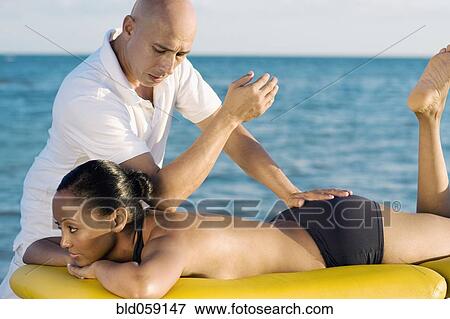 Hispanic woman receiving massage View Large Photo Image Stock Photo - Hispanic woman receiving massage. Fotosearch