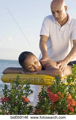 Stock Photograph - Hispanic woman receiving massage. Fotosearch