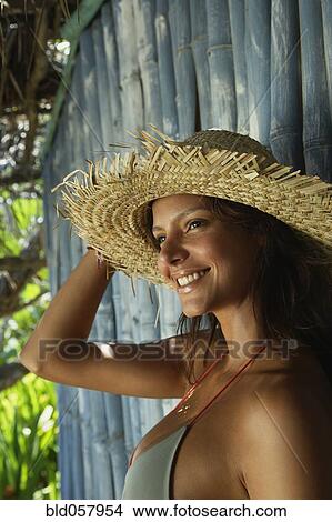 Picture - Hispanic woman wearing straw hat. Fotosearch
