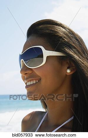 Stock Image - Hispanic woman wearing sunglasses. Fotosearch