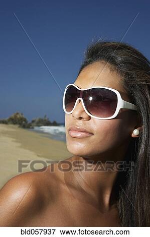 Hispanic woman wearing sunglasses View Large Photo Image Stock Photo - Hispanic woman wearing sunglasses. Fotosearch