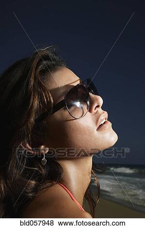 Stock Photo - Hispanic woman wearing sunglasses. Fotosearch