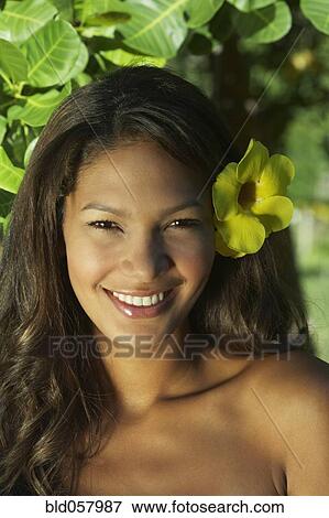 Hispanic woman with flower in hair View Large Photo Image Stock Photo - Hispanic woman with flower in hair. Fotosearch