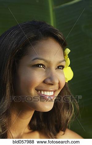 Stock Photo - Hispanic woman with flower in hair. Fotosearch