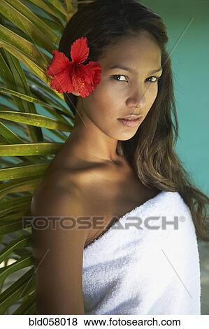Hispanic woman with flower in hair View Large Photo Image Stock Photo - Hispanic woman with flower in hair. Fotosearch