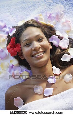 Hispanic woman with flower petals on spa table View Large Photo Image Stock Image - Hispanic woman with flower petals on spa table. Fotosearch