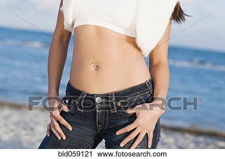 Hispanic woman with thumbs in pockets View Large Photo Image Stock Image - Hispanic woman with thumbs in pockets. Fotosearch