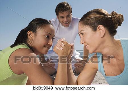 Hispanic women arm wrestling View Large Photo Image Stock Photo - Hispanic women arm wrestling. Fotosearch