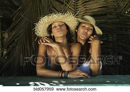 Stock Photo - Hispanic women blowing kisses. Fotosearch