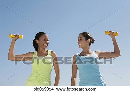 Hispanic women exercising with dumbbells View Large Photo Image Picture - Hispanic women exercising with dumbbells. Fotosearch