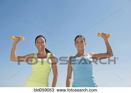 Hispanic women exercising with dumbbells View Large Photo Image Stock Image - Hispanic women exercising with dumbbells. Fotosearch