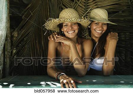 Stock Photo - Hispanic women wearing straw hats. Fotosearch
