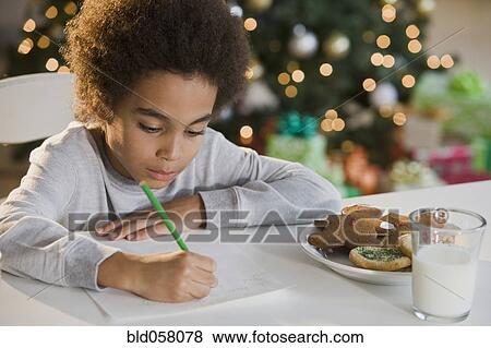 Mixed Race boy writing letter to Santa Claus View Large Photo Image Stock Photo - Mixed Race boy writing letter to Santa Claus. Fotosearch