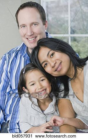 Mixed Race family hugging View Large Photo Image Stock Image - Mixed Race family hugging. Fotosearch