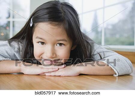 Mixed Race girl resting chin on hands View Large Photo Image Stock Photo - Mixed Race girl resting chin on hands. Fotosearch