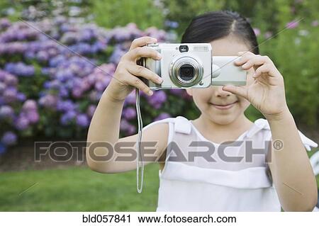 Mixed Race girl taking photograph View Large Photo Image Stock Image - Mixed Race girl taking photograph. Fotosearch