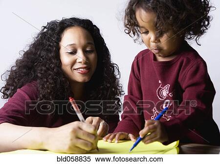Mixed Race mother and son coloring View Large Photo Image Stock Photography - Mixed Race mother and son coloring. Fotosearch