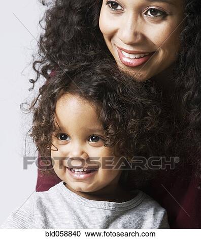 Mixed Race mother hugging son View Large Photo Image Stock Image - Mixed Race mother hugging son. Fotosearch