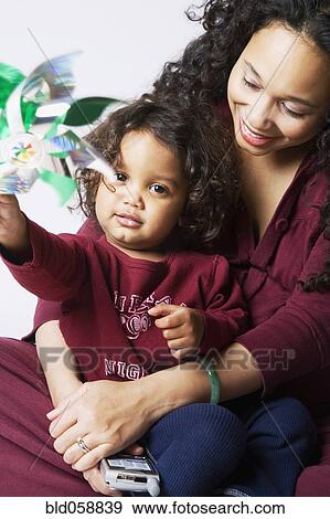 Stock Photo - Mixed Race mother hugging son. Fotosearch