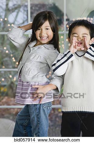 Picture - Mixed Race siblings acting silly. Fotosearch