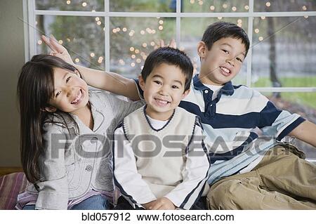 Mixed Race siblings acting silly View Large Photo Image Stock Image - Mixed Race siblings acting silly. Fotosearch