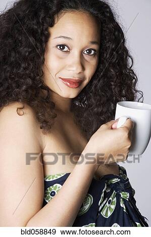 Mixed Race woman holding coffee mug View Large Photo Image Stock Photo - Mixed Race woman holding coffee mug. Fotosearch