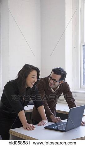 Stock Image - Multi-ethnic businesspeople laughing. Fotosearch
