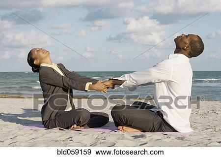 Stock Photo - Multi-ethnic businesspeople stretching. Fotosearch