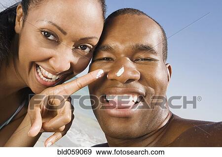 Stock Photo - Multi-ethnic couple laughing. Fotosearch