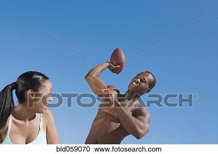 Multi-ethnic couple playing football View Large Photo Image Stock Image - Multi-ethnic couple playing football. Fotosearch